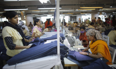 Employees work in a factory of Babylon Garments in Dhaka January 3, 2014. On the outskirts of Dhaka, Babylon Garments has shortened work shifts to eight hours from the usual 10 and plans to shutter production lines as months of election-related violence disrupts transport and prompts global retailers to curb orders. Picture taken January 3, 2014. To match BANGLADESH-GARMENTS/ REUTERS/Andrew Biraj (BANGLADESH - Tags: BUSINESS EMPLOYMENT TEXTILE) - RTX175UR