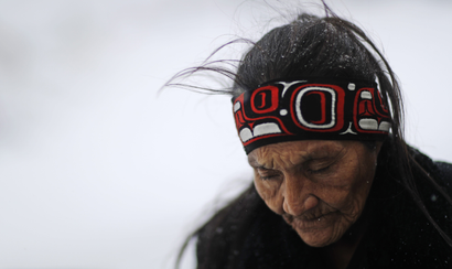 In this Tuesday, Nov. 29, 2016 photo, Grandma Redfeather of the Sioux Native American tribe walks in the snow to get water at the Oceti Sakowin camp where people have gathered to protest the Dakota Access oil pipeline in Cannon Ball, N.D. "It's for my people to live and so that the next seven generations can live also," said Redfeather of why she came to the camp. "I think about my grandchildren and what it will be like for them."
