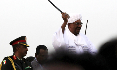Sudanese President Omar al-Bashir (C) waves to his supporters at the airport in the capital Khartoum, Sudan, June 15, 2015, on arrival after attending an African Union conference in Johannesburg South Africa. Al-Bashir flew out of South Africa on Monday in defiance of a Pretoria court that later said he should have been arrested to face genocide charges at the International Criminal Court. Despite a legal order for him to stay in the country ahead of the ruling on his detention, the government let Bashir leave unhindered, with South Africa's ruling party accusing the ICC of being biased against Africans and "no longer useful".
