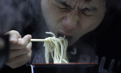 A man eats noodle at a restaurant in Shanghai March 2, 2009. China said on Monday food security remains "grim", despite campaigns launched after several health scares, the most recent last year's tainted milk formula which killed at least six toddlers and made almost 300,000 sick.