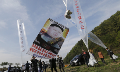 North Korean defectors prepare to release balloons carrying leaflets and a banner condemning North Korean leader Kim Jong Un during a rally against North Korea in Paju, near the border with North Korea, South Korea, Friday, April 29, 2016. North Korea on Friday accused U.S. soldiers of trying to provoke its frontline troops with "disgusting" acts and encouraging South Korean soldiers to aim their guns at the North. The banner reads " End the three generation dictatorship."