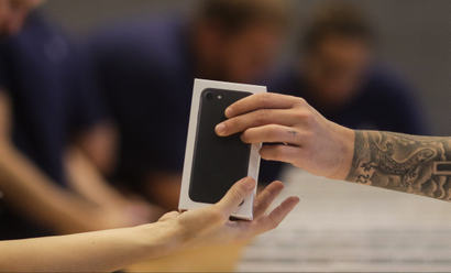 Apple shop staff hand out the new iPhone 7 to customers at the Apple store in Berlin, Friday, Sept. 16, 2016. Apple's newest mobile devices, the iPhone 7 and 7 Plus went on sale in the country on Friday. (AP Photo/Markus Schreiber)
