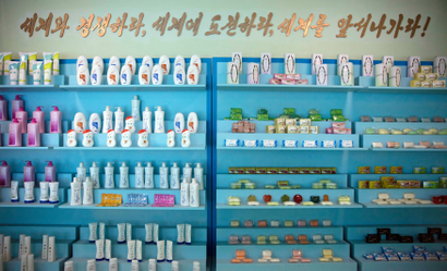 Inside the Pyongyang Cosmetics Factory. The slogan reads: “Compete with the world, challenge the world, go lead the world!”