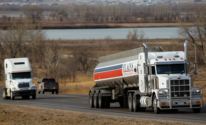 In this March 23, 2012, photo semi-trucks drive south on Highway 85 near Williston, N.D. Litter has become an escalating problem as the rush to tap vast caches of crude escalates in North Dakota. Some of the industrial rubbish blows in from unsecured truckloads, but for many, the most frustrating trash is the gallons of discarded urine. (AP Photo/Elijah Nouvelage)