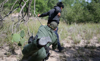 A man who illegally crossed the Mexico-U.S. border evades a U.S. Border Patrol agent near McAllen, Texas, U.S., May 8, 2018.