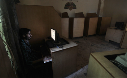A man uses the computer at an internet cafe in Rawalpindi