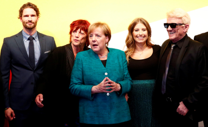 German Chancellor Angela Merkel poses with supporters during a reception at the CDU party election campaign meeting centre in Berlin