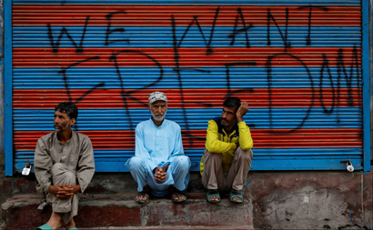 Kashmiri men wait before Eid-al-Adha prayers during restrictions after the scrapping of the special constitutional status for Kashmir by the Indian government, in Srinagar, August 12, 2019.