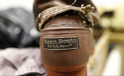 In this Friday, Feb. 2, 2018 photo a Bean Boot is seen in the return bin at L.L. Bean retail store in Freeport, Maine. Although the company is changing its return policy it will always accept returns on products that have failed, such as this boot. (AP Photo/Robert F. Bukaty)