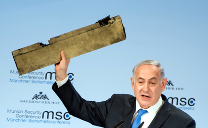 Israeli Prime Minister Benjamin Netanyahu holds up a remnant of what he said was a piece of Iranian drone which was shot down in Israeli airspace during his speech at the Munich Security Conference, Germany February 18, 2018.