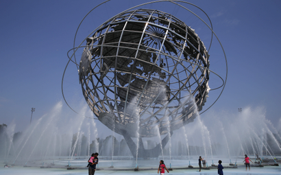 People cool off in the water at the Unisphere at Flushing Meadows Corona Park in the Queens borough of New York