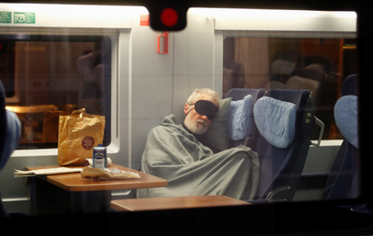 A traveller sleeps in a German high-speed train