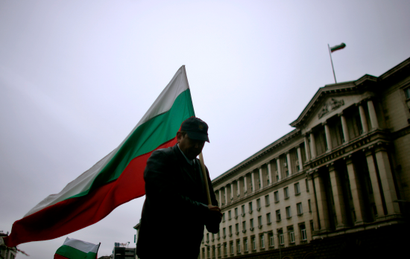 A man holds the Bulgarian flag during a protest in central Sofia