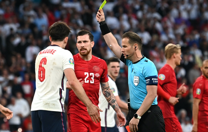 England's Harry Maguire is shown a yellow card by referee Danny Makkelie as Denmark's Pierre-Emile Hojbjerg look on