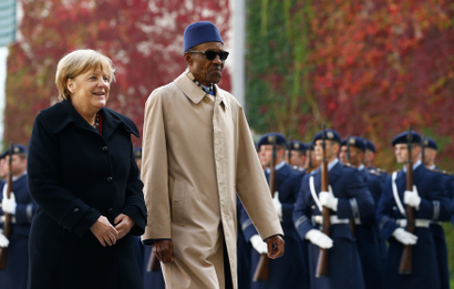 German Chancellor Merkel and Nigerian President Buhari review the honour guard during a welcoming ceremony at the chancellery in Berlin