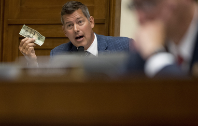 Rep. Sean Duffy, R-Wis., holds up a twenty dollar bill as he questions David Marcus, CEO of Facebook's Calibra digital wallet service, as he appears before a House Financial Services Committee hearing on Facebook's proposed cryptocurrency on Capitol Hill in Washington, Wednesday, July 17, 2019.