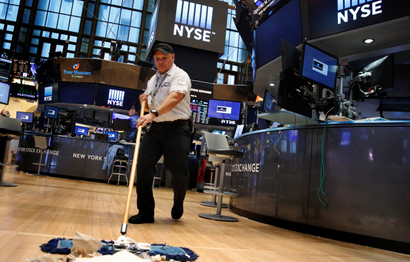 A worker cleans the floor of the New York Stock Exchange (NYSE) after the close of trading in New York