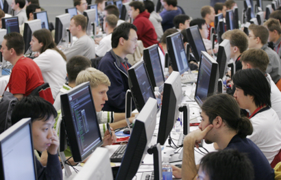 Contestants in the 2006 Google Global Code Jam stare at their computer screens at Google's New York office Friday, Oct. 27, 2006. One hundred of the best computer coders from around the world compete for prize money and bragging rights. The finalists from 20 countries are flown to New York by Google for the competition. (AP Photo/Mark Lennihan)