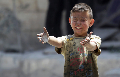 A boy, whose brother was killed, reacts at a site hit by airstrikes in the rebel-controlled area of Maaret al-Numan town in Idlib province, Syria June 2, 2016.