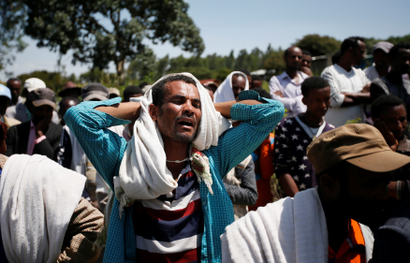 A man mourns during the funeral of Tesfu Tadese Biru, a construction engineer who died during a stampede after police fired warning shots at an anti-government protest in Bishoftu during Irreecha in Denkaka Kebele