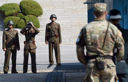 North Korean soldiers, left, look at the South side while U.S. Defense Secretary Jim Mattis and South Korean Defense Minister Song Young-moo visit the truce village of Panmunjom in the Demilitarized Zone (DMZ) on the border between North and South Korea Friday, Oct. 27, 2017. (Jung Yeon-je/Pool Photo via AP)