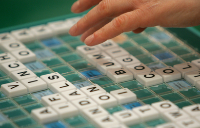 A competitor takes part in the World Scrabble Championships in London.