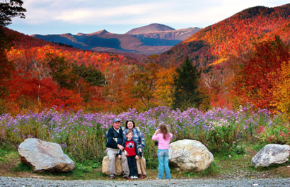 Wildflowers, fall foliage and 6,288-foot Mt. Washington serve as a backdrop for Jim and Kathleen Gannon and their son James as their daughter Katarina snaps a picture at Crawford Notch State Park in New Hampshire, Friday, Oct. 6, 2006.
