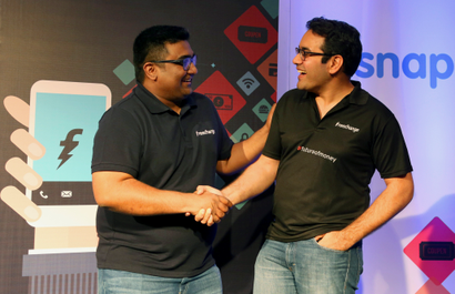 Kunal Bahl, right, co-founder and Chief Executive Officer (CEO) of Snapdeal and Kunal Shah co-founder and CEO of FreeCharge share a laugh after the launch of Digital Wallet in Bangalore, India