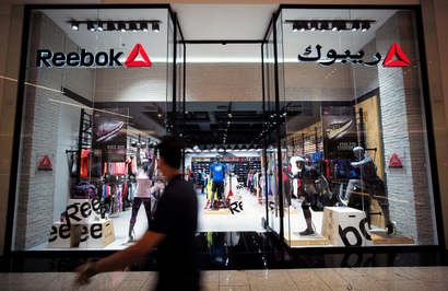 A man walks by a Reebok store in Bahrain.