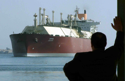 A tanker carrying natural gas steams through the Suez Canal. Egypt is cutting its own electricity use in order to export more natural gas.