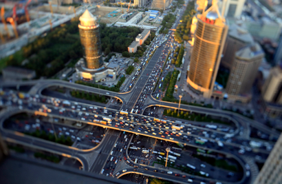 Vehicles drive on the Guomao Bridge during the evening rush hour in Beijing, September 3, 2014. Picture taken using a tilt shift lens.