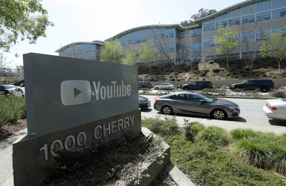 A YouTube sign is shown across the street from the company's offices in San Bruno, Calif., Tuesday, April 3, 2018. A woman opened fire at YouTube headquarters Tuesday, setting off a panic among employees and wounding several people before fatally shooting herself, police and witnesses said.