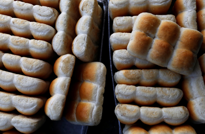 Baked buns are seen seen in trays at a bakery in Mumbai