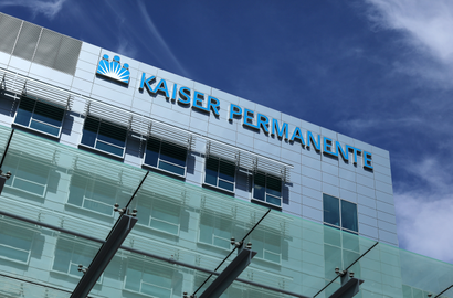 A Kaiser Permanent building pictured against a blue sky.
