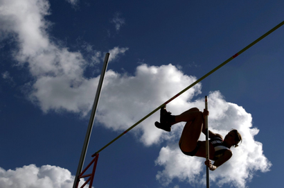 silhouette of a woman pole vaulting