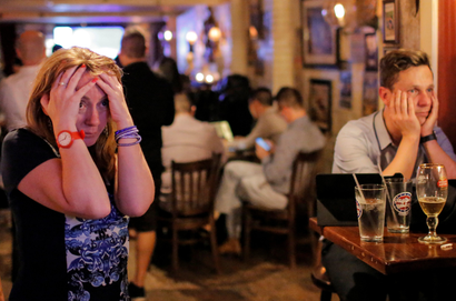 People gathered in The Churchill Tavern, a British themed bar, react as the BBC predicts Briatin will leave the European Union, in the Manhattan borough of New York, U.S., June 23, 2016.