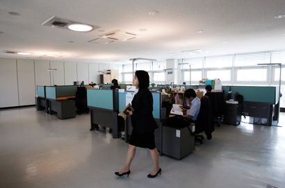 Officials of the National Institute of Environmental Research (NIER) work in the office at its zero carbon building in Incheon, west of Seoul, May 16, 2011. South Korea has opened what it says is the ultimate eco-friendly business centre, a construction that emits zero carbon and uses only renewable energy, in a project to underline the government's commitment to reduce greenhouse gases. The 2,500 square-metre building, which houses a climate change research centre at Incheon near the capital Seoul, was opened in April by the environment ministry at a cost of around $8 million. Picture taken May 16. To match Reuters Life! KOREA-GREEN/ REUTERS/Truth Leem (SOUTH KOREA - Tags: ENVIRONMENT SOCIETY BUSINESS CONSTRUCTION ENERGY) - GM1E75K1K5Q01