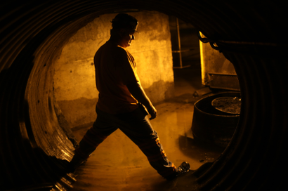 Coal miner Mike Hawks, 53, stands in an underground tunnel at a coal processing facility near Gilbert, West Virginia May 22, 2014. With coal production slowing due to stricter environmental controls, the availability of natural gas and a shift to surface mining, the state's coal country has been hit hard with job losses and business closures..