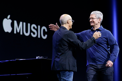 FILE - In this June 8, 2015 file photo, Apple CEO Tim Cook, right, hugs Beats by Dre co-founder and Apple employee Jimmy Iovine at the Apple Worldwide Developers Conference in San Francisco when Apple announced Apple Music, an app that combines a 24-hour, seven-day live radio station called "Beats 1" with an on-demand music streaming service. Apple Inc. says it has 15 million users on its streaming-music service, including 6.5 million paying subscribers. The Wall Street Journal says (http://on.wsj.com/1LAy1Mz ) in a report from Laguna Beach, California, posted early Tuesday, Oct. 20 on its website that Apple launched Apple Music on June 30 and offered every user a three-month trial period. (AP Photo/Jeff Chiu, File)