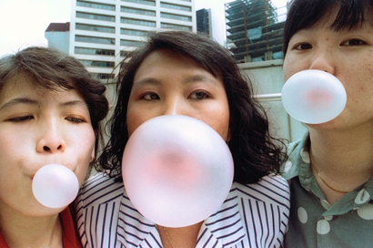 SINGAPOREANS POSE WHILE BLOWING BUBBLES A FEW DAYS BEFORE CHEWING GUMWAS BANNED.