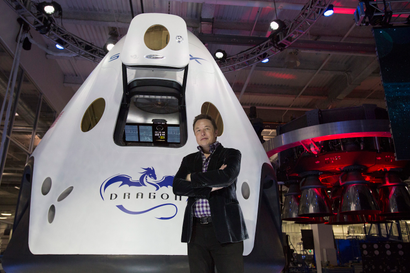 SpaceX CEO Musk poses by the Dragon V2 spacecraft after it was unveiled in Hawthorne