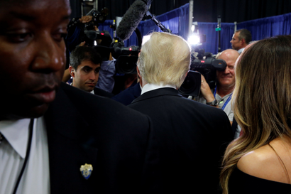 Donald Trump's back is seen as he talks to reporters