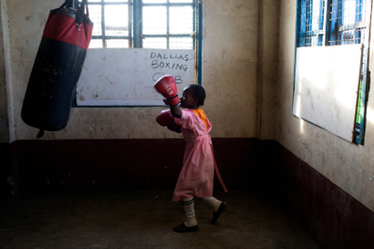 A girl practices boxing at a local gym for disadvantaged youth in Kamukunnji
