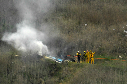 Firefighters work at the scene of the crash where former NBA star Kobe Bryant died.