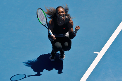 Serena Williams clenches fists in victory.
