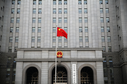 A Chinese national flag flutters in front of the building of the Number 2 Intermediate People's Court in Beijing, China September 22, 2016.