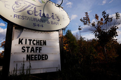 A help wanted sign outside a restaurant.
