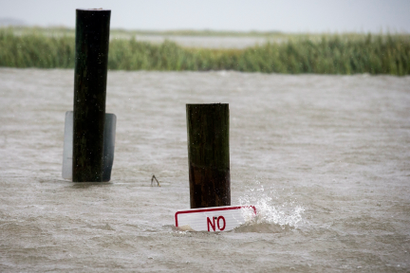 A sign at the Lazaretto Creek boat ramp as is nearly underwater at high tide as Hurricane Dorian makes its way up the east coast, Wednesday, Sept. 4, 2019, toward Tybee Island, Ga. Dorian is forecast to bring storm surge and tropical storm force winds the barrier island. (AP Photo/Stephen B. Morton)