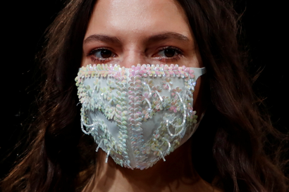 A model presents a face mask, a creation by 050 brand during Mercedes-Benz Fashion Week Russia amid the coronavirus disease (COVID-19) outbreak in Moscow