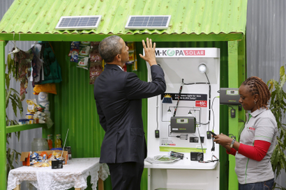 U.S. President Barack Obama (L) talks with a solar power businessperson at the Power Africa Innovation Fair at the United Nations compound in Nairobi, Kenya July 25, 2015.